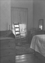 SA0674 - View of a Shaker interior, showing a rocking chair, chest of drawers, and dressing table.